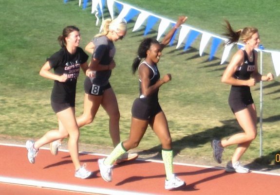 Lindsay Witteman, Aimee Rodgers, Michelle Burley, Kelly Clancey, cooling down after finishing fourth in the 4 X 400 relay and thus assuring the conference title